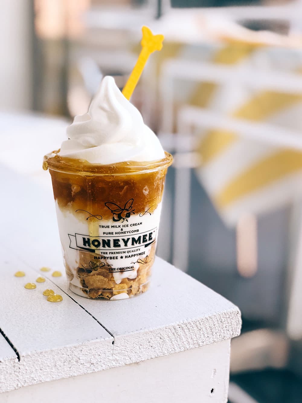 Honeymee affogato cup with soft serve and a yellow straw