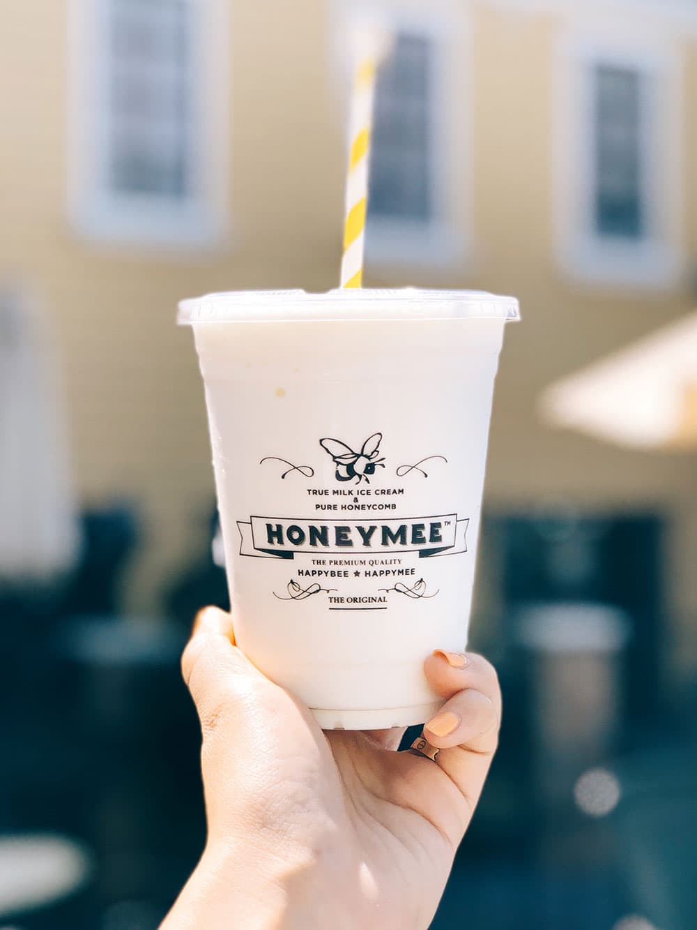 Honeymee milkshake held up outside the shop