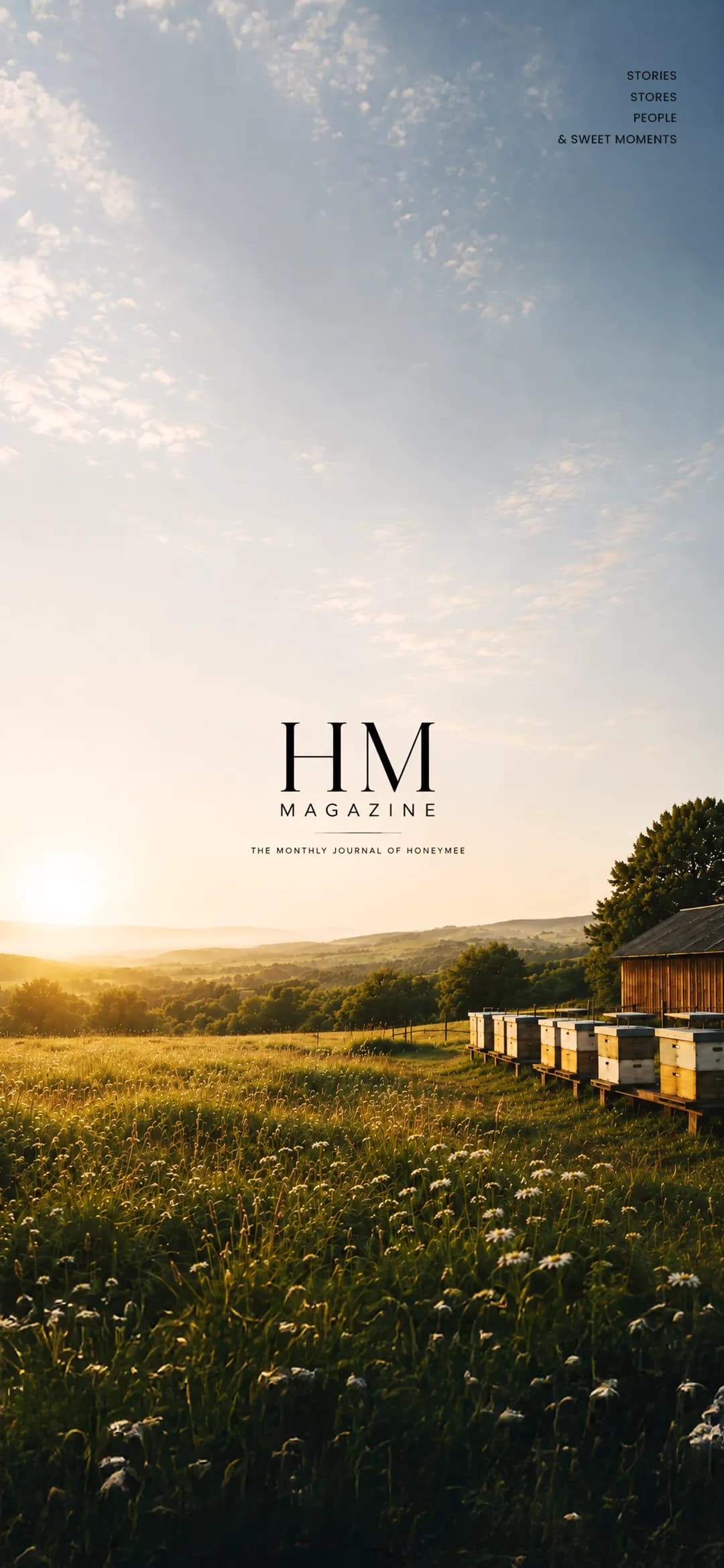 HM Magazine cover, the monthly journal of Honeymee: beehives in a meadow at sunrise. Stories, stores, people and sweet moments.
